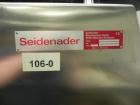 Used Seidenader Model V90-AVSB/60-LR Vial Inspection Machine. Capable of speeds up to 150 objects per minute. Has starwheel tray infeed and straight line discharge to tray. Machine equipped for vials...