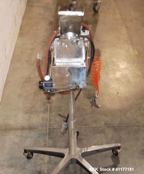 Used Key International Tablet Deduster, Model TD-101, 304 Stainless Steel. Air volume 1 to 2 cfm, vacuum 20 to 30, nozzle for dust control. Mounted on stand with casters.