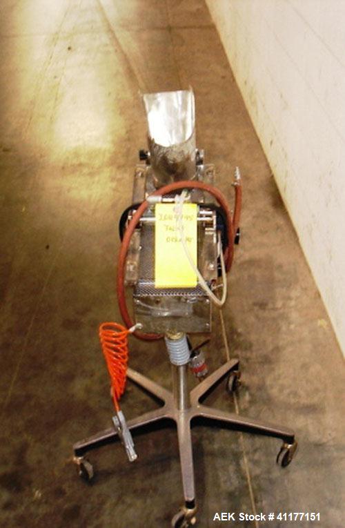 Used Key International Tablet Deduster, Model TD-101, 304 Stainless Steel. Air volume 1 to 2 cfm, vacuum 20 to 30, nozzle for dust control. Mounted on stand with casters.