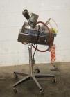Used Key International Tablet Deduster, Model TD-101, 304 Stainless Steel. Air volume 1 to 2 cfm, vacuum 20 to 30, nozzle for dust control. Mounted on stand with casters.