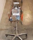 Used Key International Tablet Deduster, Model TD-101, 304 Stainless Steel. Air volume 1 to 2 cfm, vacuum 20 to 30, nozzle for dust control. Mounted on stand with casters.