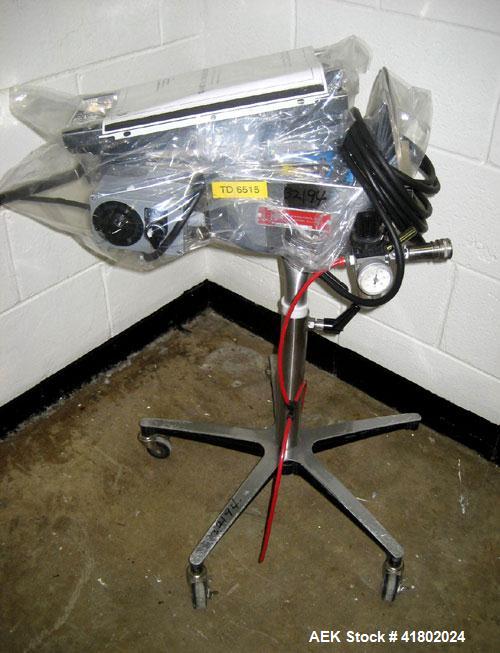 Used Key International Tablet Deduster, Model TD-101, 304 Stainless Steel. Air volume 1 to 2 cfm, vacuum 20 to 30 cfm. 115 volt. Mounted on stand with casters.
