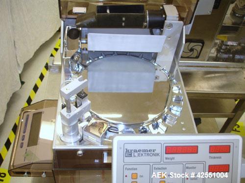 Used Kraemer Elektronik Universal Testing Machine, Model UTS. Fully automatic testing of the parameters weight, thickness, diameter and hardness. Rotary tablet table with Mettler Toledo scale. 90-264...