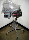 Used Key International Tablet Deduster, Model TD-101, 304 Stainless Steel. Air volume 1 to 2 cfm, vacuum 20 to 30 cfm. 115 volt. Mounted on stand with casters.