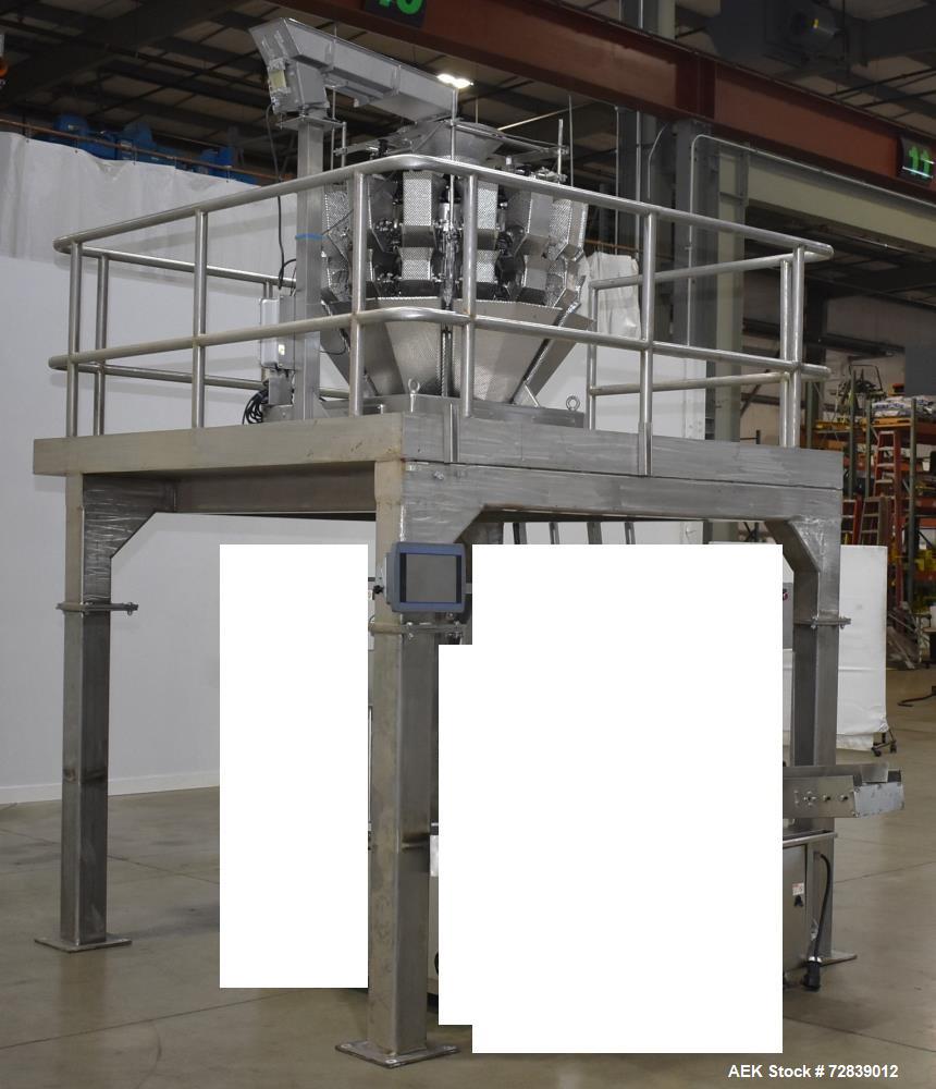 Used Ohlson Model 14-2C-18F Radial Combination Scale and Platform. 14-Dimple buckets. Weighing range approcimate 10 - 3000g. Max cycle speed 130 WPM. Has Syntron BF-2-B magnetic feeder. Serial# 88160...