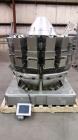 Used Ishida CCW-NZ-214W-S/70-WP. Fully wash down with dimpled buckets and chutes. Perfect for any products like, lettuce, beef jerky, vegetables, sausage patties, gummies, etc... Scale has a timing h...