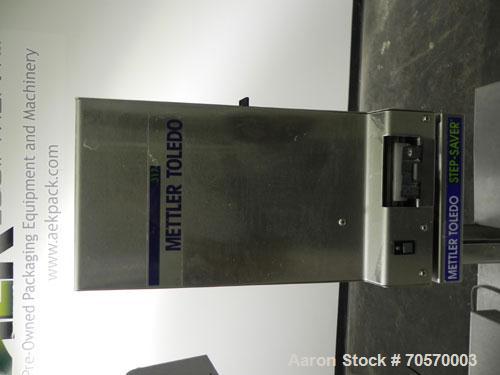 Used Mettler-Toledo Model 662 StepSaver Manual Weigh-Wrap Center. Consists of a SmartTouch Readout, model 8270 scale, stainless steel platform, capacity 50 x .01 pounds, model 317 label printer, labe...