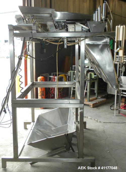 Used Weigh Right PMB-4 net weigher is a four-head scale offering speeds up to 40 fills per minute. Approximately 3-1/2" outlets on 18" centers with a 40" discharge height. The scale is designed to ha...