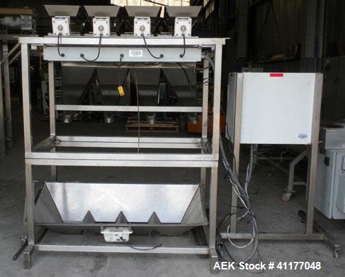 Used Weigh Right PMB-4 net weigher is a four-head scale offering speeds up to 40 fills per minute. Approximately 3-1/2" outlets on 18" centers with a 40" discharge height. The scale is designed to ha...