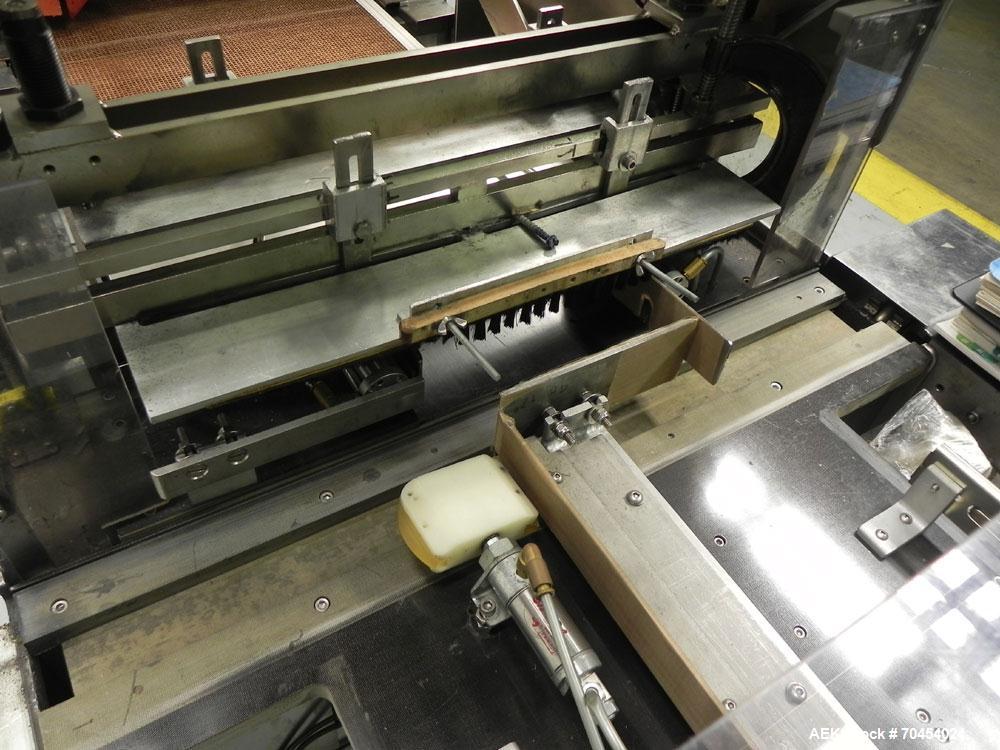 Used Omega Design Model SL-18 Single Lane Shrink Bundler. Machine is capable of speeds from 120 to 150 containers per minute. Has right angle infeed and integrated heat shrink tunnel. Has a maximum f...