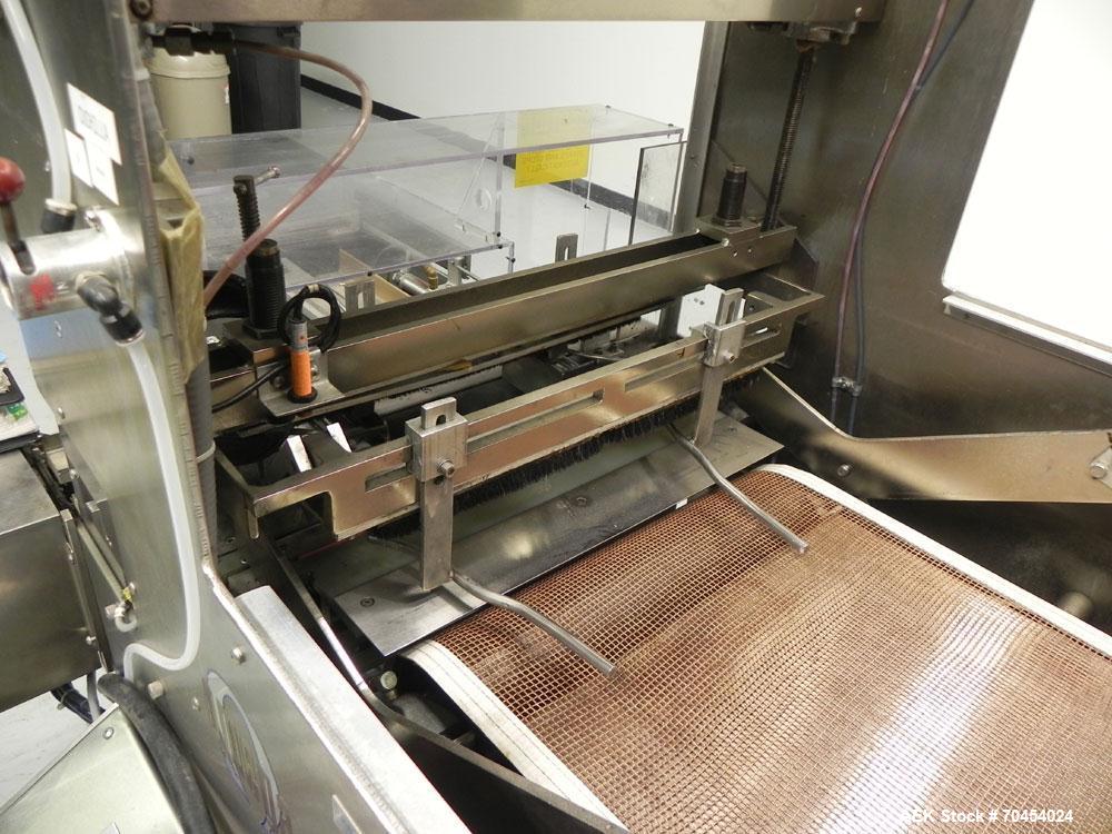 Used Omega Design Model SL-18 Single Lane Shrink Bundler. Machine is capable of speeds from 120 to 150 containers per minute. Has right angle infeed and integrated heat shrink tunnel. Has a maximum f...