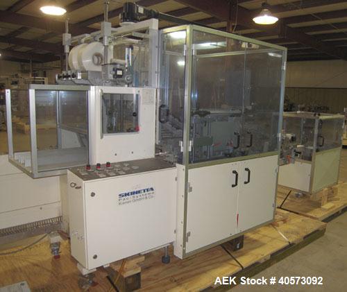 Used Skinetta ASK 450T Shrink Bander/Bundler. Capable of speeds from 10 to 40 cycles per minute. Has inline feed and optional right angle carton collator. Max 450mm web width. Has upstacker. Last use...