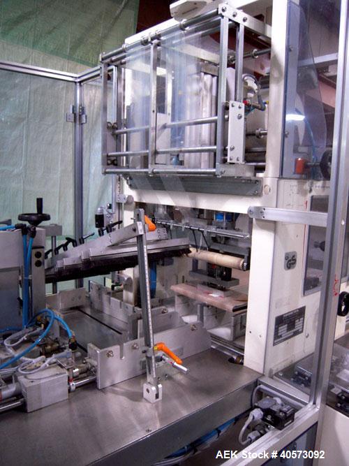Used Skinetta ASK 450T Shrink Bander/Bundler. Capable of speeds from 10 to 40 cycles per minute. Has inline feed and optional right angle carton collator. Max 450mm web width. Has upstacker. Last use...