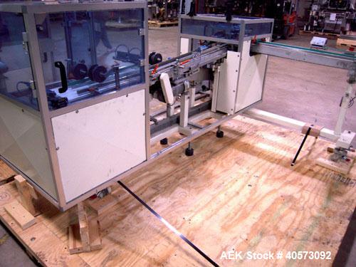 Used Skinetta ASK 450T Shrink Bander/Bundler. Capable of speeds from 10 to 40 cycles per minute. Has inline feed and optional right angle carton collator. Max 450mm web width. Has upstacker. Last use...