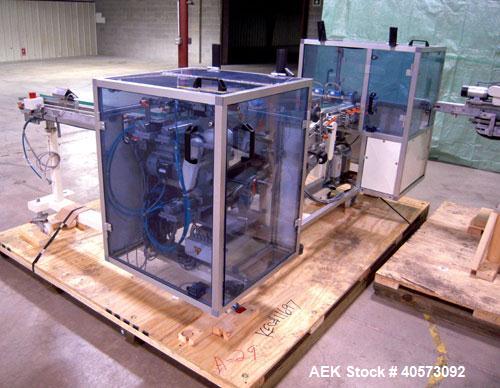 Used Skinetta ASK 450T Shrink Bander/Bundler. Capable of speeds from 10 to 40 cycles per minute. Has inline feed and optional right angle carton collator. Max 450mm web width. Has upstacker. Last use...
