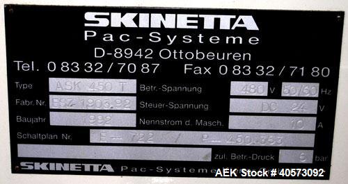 Used Skinetta ASK 450T Shrink Bander/Bundler. Capable of speeds from 10 to 40 cycles per minute. Has inline feed and optional right angle carton collator. Max 450mm web width. Has upstacker. Last use...