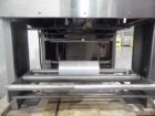 Used API Stainless Steel Pharmaceutical Shrink Bundler, Model Duratech 2000 S-PH. Integrated heat tunnel. Capable of up to 100 round or rectangular shaped containers depending on pattern and size. Si...