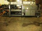 Used American Packaging Machinery (APM) Automatic Inline Shrink Bundler, Series MIF. Designed for trayed products. Capable of speeds up to 45 trays per minute. Intermittent motion unit with integrate...