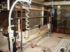 Used American Packaging Machinery (APM) Automatic Inline Shrink Bundler, Series MIF. Designed for trayed products. Capable of speeds up to 45 trays per minute. Intermittent motion unit with integrate...