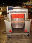 Used American Packaging Machinery (APM) Automatic Inline Shrink Bundler, Series MIF. Designed for trayed products. Capable of speeds up to 45 trays per minute. Intermittent motion unit with integrate...