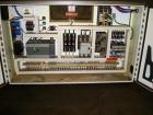 Used American Packaging Machinery (APM) Automatic Inline Shrink Bundler, Series MIF. Designed for trayed products. Capable of speeds up to 45 trays per minute. Intermittent motion unit with integrate...