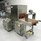 Used Omega Design Model SL-18 Single Lane Shrink Bundler. Machine is capable of speeds from 120 to 150 containers per minute. Has right angle infeed and integrated heat shrink tunnel. Has a maximum f...