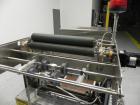 Used Omega Design Model SL-18 Single Lane Shrink Bundler. Machine is capable of speeds from 120 to 150 containers per minute. Has right angle infeed and integrated heat shrink tunnel. Has a maximum f...