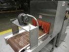 Used Omega Design Model SL-18 Single Lane Shrink Bundler. Machine is capable of speeds from 120 to 150 containers per minute. Has right angle infeed and integrated heat shrink tunnel. Has a maximum f...