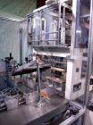 Used Skinetta ASK 450T Shrink Bander/Bundler. Capable of speeds from 10 to 40 cycles per minute. Has inline feed and optional right angle carton collator. Max 450mm web width. Has upstacker. Last use...