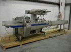 USED: Doboy Linium 305 horizontal shrink wrapper capable of speeds up to 200 packages per minute. Servo driven system, has 10' long infeed, static lap seam seal. Will handle most heat sealable shrink...