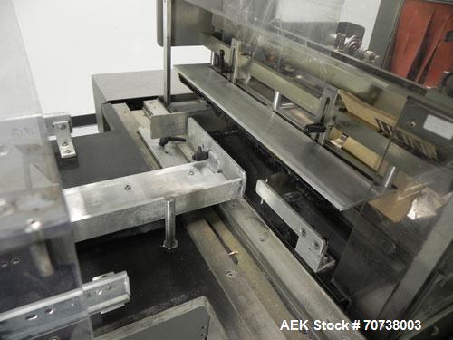 Used Omega Model SL18 Shrink Bundling System with Integrated Shrink Tunnel. Capable of up to 15-20 cycles per minute. Right angle product infeed for 4-1/2”W table top chain, infeed conveyor not inclu...