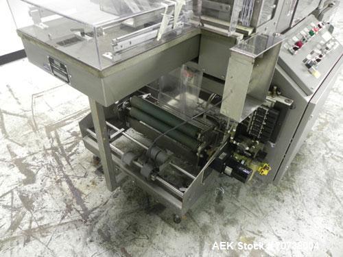 Used Omega Model SL18 Shrink Bundling System with Integrated Shrink Tunnel. Capable of up to 15-20 cycles per minute. Right angle product infeed for 4-1/2”W table top chain, infeed conveyor not inclu...