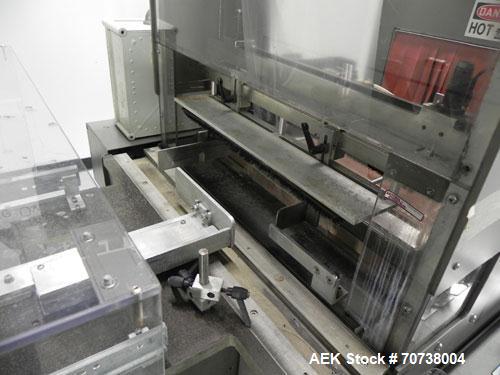Used Omega Model SL18 Shrink Bundling System with Integrated Shrink Tunnel. Capable of up to 15-20 cycles per minute. Right angle product infeed for 4-1/2”W table top chain, infeed conveyor not inclu...