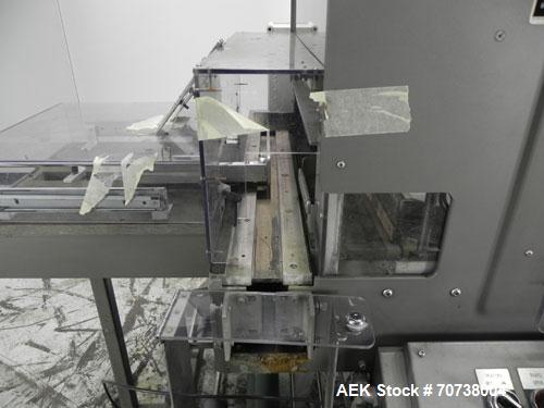Used Omega Model SL18 Shrink Bundling System with Integrated Shrink Tunnel. Capable of up to 15-20 cycles per minute. Right angle product infeed for 4-1/2”W table top chain, infeed conveyor not inclu...