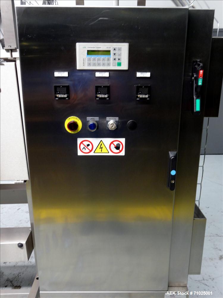 Used Sacmi Sleeve Labeling Electric Heat Tunnel. Has 3 zones, each zone has 72" long x 4.75" tall heater bars, and in/out feed opening of 9.5" wide x 33" tall. Equipped with (3) Leister electric heat...