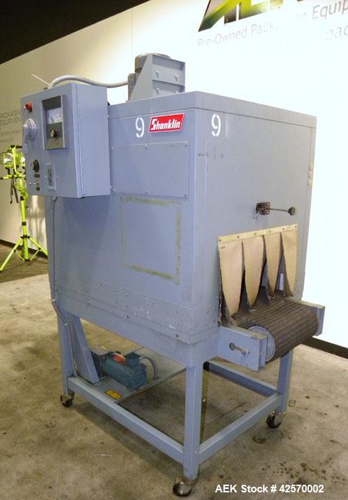 Used Shanklin Shrink Tunnel Model T-7XL. Machine is of carbon steel construction. Tunnel passage 8" high x 22" wide x 42" long. 15" Wide x 52" long wire mesh conveyor, 15 to 120 feet per minute. Driv...