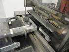 Used Omega Model SL18 Shrink Bundling System with Integrated Shrink Tunnel. Capable of up to 15-20 cycles per minute. Right angle product infeed for 4-1/2”W table top chain, infeed conveyor not inclu...