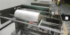 Used Omega Model SL18 Shrink Bundling System with Integrated Shrink Tunnel. Capable of up to 15-20 cycles per minute. Right angle product infeed for 4-1/2”W table top chain, infeed conveyor not inclu...