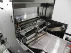 Used Omega Model SL18 Shrink Bundling System with Integrated Shrink Tunnel. Capable of up to 15-20 cycles per minute. Right angle product infeed for 4-1/2”W table top chain, infeed conveyor not inclu...