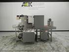 Used Omega Model SL18 Shrink Bundling System with Integrated Shrink Tunnel. Capable of up to 15-20 cycles per minute. Right angle product infeed for 4-1/2”W table top chain, infeed conveyor not inclu...