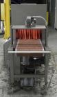 Used Omega Model SL18 Shrink Bundling System with Integrated Shrink Tunnel. Capable of up to 15-20 cycles per minute. Right angle product infeed for 4-1/2”W table top chain, infeed conveyor not inclu...