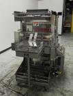 Used Omega Model SL18 Shrink Bundling System with Integrated Shrink Tunnel. Capable of up to 15-20 cycles per minute. Right angle product infeed for 4-1/2”W table top chain, infeed conveyor not inclu...