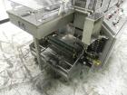 Used Omega Model SL18 Shrink Bundling System with Integrated Shrink Tunnel. Capable of up to 15-20 cycles per minute. Right angle product infeed for 4-1/2”W table top chain, infeed conveyor not inclu...