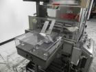Used Omega Model SL18 Shrink Bundling System with Integrated Shrink Tunnel. Capable of up to 15-20 cycles per minute. Right angle product infeed for 4-1/2”W table top chain, infeed conveyor not inclu...