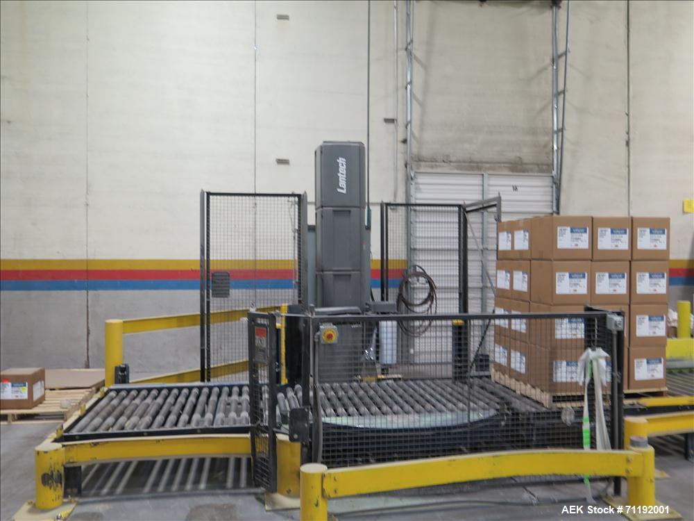 Used Lantech Stretch Wrapper, Model Q1000 Serial # QA 002180.  Automatic operation with powered infeed and discharge pallet conveyors, 18" elevation.   Max 92" load height (incl pallet), Max 4,000 lb...