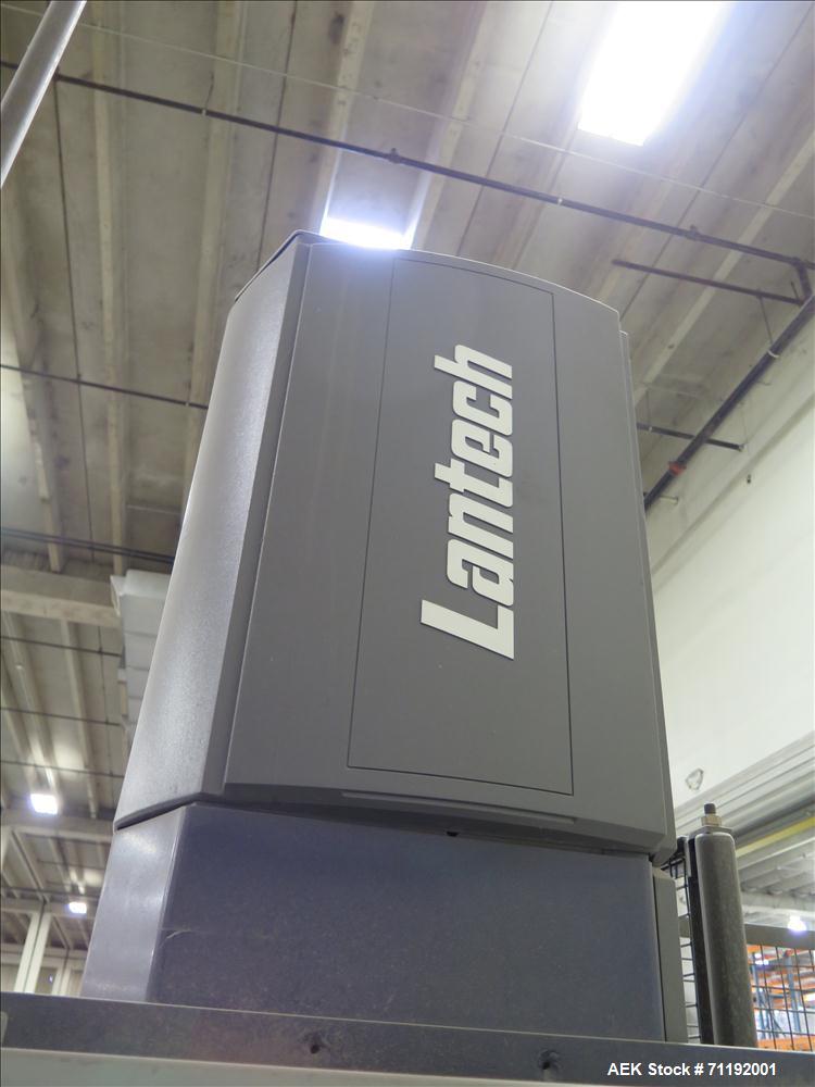 Used Lantech Stretch Wrapper, Model Q1000 Serial # QA 002180.  Automatic operation with powered infeed and discharge pallet conveyors, 18" elevation.   Max 92" load height (incl pallet), Max 4,000 lb...