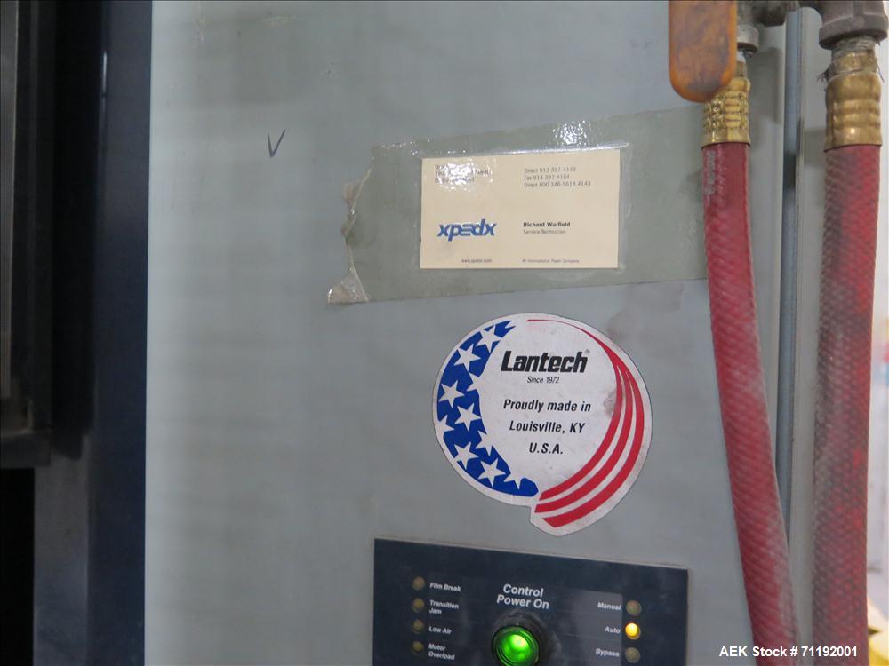 Used Lantech Stretch Wrapper, Model Q1000 Serial # QA 002180.  Automatic operation with powered infeed and discharge pallet conveyors, 18" elevation.   Max 92" load height (incl pallet), Max 4,000 lb...