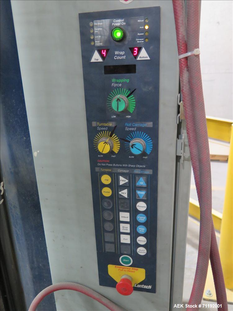 Used Lantech Stretch Wrapper, Model Q1000 Serial # QA 002180.  Automatic operation with powered infeed and discharge pallet conveyors, 18" elevation.   Max 92" load height (incl pallet), Max 4,000 lb...