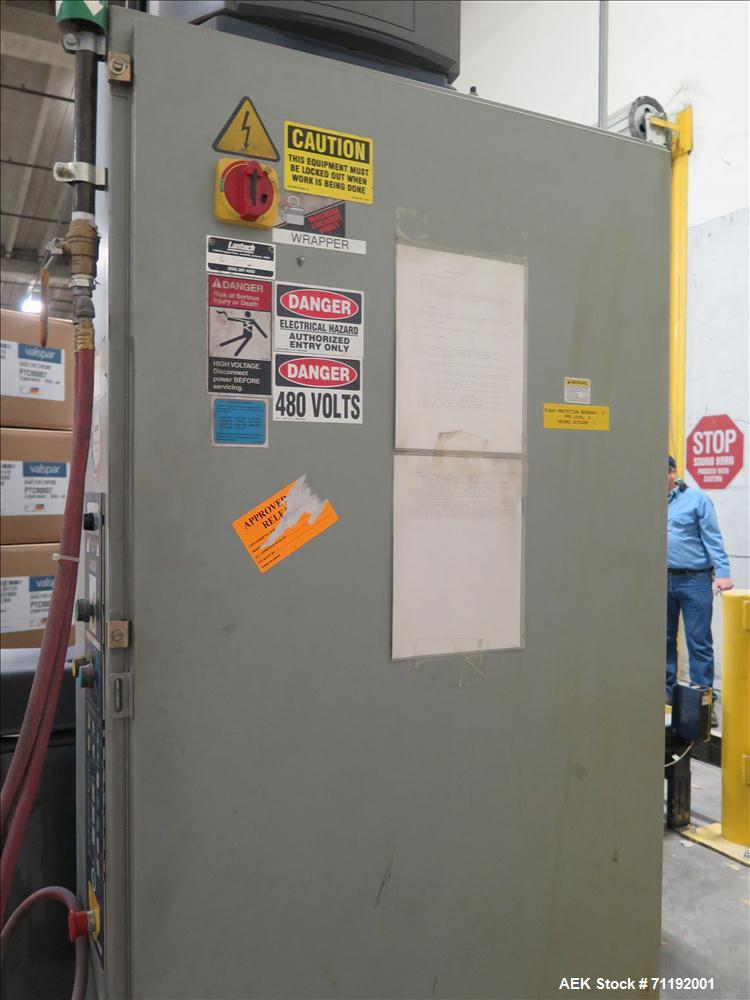 Used Lantech Stretch Wrapper, Model Q1000 Serial # QA 002180.  Automatic operation with powered infeed and discharge pallet conveyors, 18" elevation.   Max 92" load height (incl pallet), Max 4,000 lb...