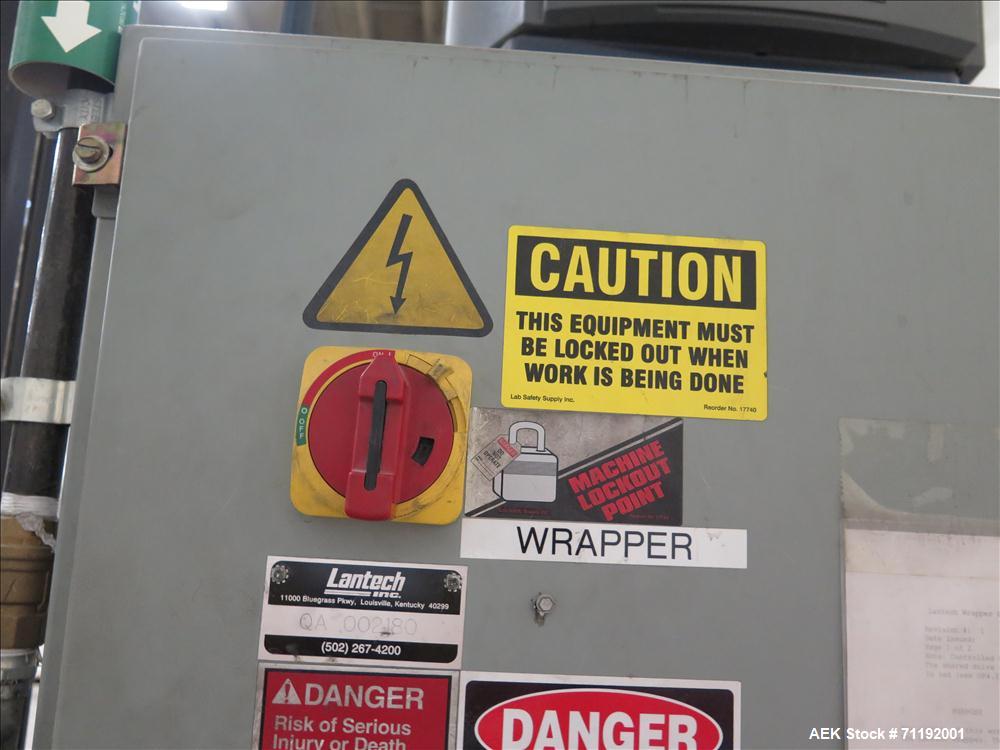 Used Lantech Stretch Wrapper, Model Q1000 Serial # QA 002180.  Automatic operation with powered infeed and discharge pallet conveyors, 18" elevation.   Max 92" load height (incl pallet), Max 4,000 lb...